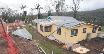 ?? ?? A home at Guanaba was unrecogniz­able after storms then floods. Picture: Glenn Hampson