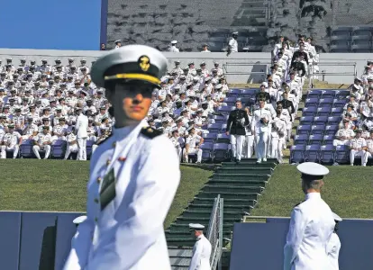  ?? MICHAEL ROBINSON CHÁVEZ/WASHINGTON POST FILE PHOTO ?? Naval Academy graduates file into Navy-Marine Corps Memorial Stadium for their graduation ceremony May 26. A leadership transition at the academy has been held up because Sen. Tommy Tuberville, R-Ala., objects to a military policy on abortion access.