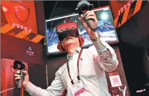  ?? REUTERS ?? A visitor tries a pair of HTC Vive virtual reality (VR) goggles, during the annual Computex computer exhibition in Taipei, Taiwan province.