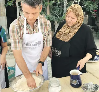  ?? LISA KADANE ?? Blake Ford kneads dough for fresh pitas at the Beit Sitti school in Jordan.