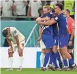  ?? ?? U.S. players celebrate after defeating Iran in their final match in the group stage. The U.S. team advances to the knockout round.