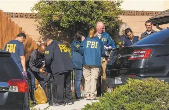  ?? Apu Gomes / AFP / Getty Images ?? FBI agents collect evidence Thursday at the home of nightclub shooter Ian David Long in Thousand Oaks (Ventura County). The ex-Marine fatally shot 12 people before killing himself.