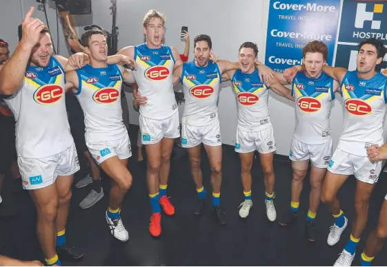  ?? Picture: GETTY IMAGES ?? Suns players belt out their song after a thrilling victory over the Lions at the Gabba last night.