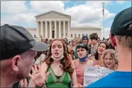  ?? GEMUNU AMARASINGH­E/AP PHOTO ?? Abortion-rights protesters and anti-abortion protesters face off following Supreme Court’s decision to overturn Roe v. Wade Friday in Washington.