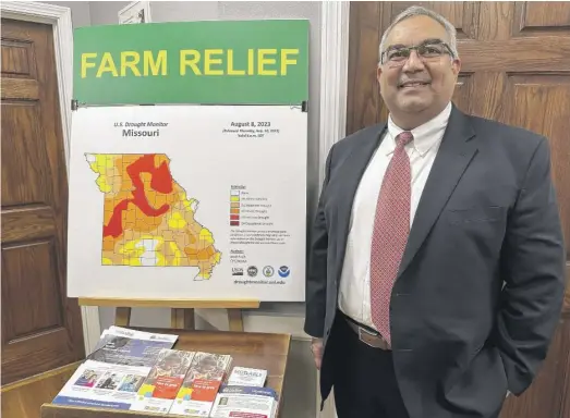  ?? DAVID A. LIEB/AP ?? Missouri Treasurer Vivek Malek stands near a poster promoting drought conditions and state aid programs on Jan. 4 at his Capitol office in Jefferson City, Mo. His office was swamped with requests for agricultur­al and small-business loans at the beginning of the year.