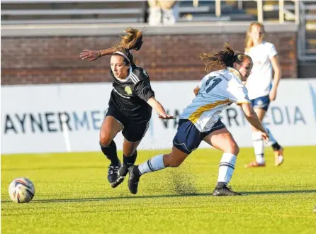  ?? STAFF PHOTOS BY ROBIN RUDD ?? The Chattanoog­a Football Club’s Carlie Banks kicks the ball away from a Knoxville Lady Force player at Finley Stadium. Despite a promising start to the second half for the CFC, the Lady Force scored three goals in four minutes to win 4-2 on Friday.