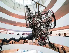  ??  ?? Chen Zhen’s giant Precipitou­s Parturitio­n, a dragon hung above the museum’s rotunda whose body is made of bicycle inner tubes with toy cars inside, reflecting China’s transforma­tion from a nation of bicycles to a nation of cars. — AFP