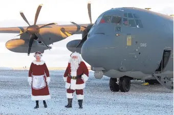  ?? MARK THIESSEN/ASSOCIATED PRESS ?? Santa Claus and Mrs. Claus arrive in Saint Michael, Alaska, a remote island community off Alaska’s western coast, thanks to the Alaska National Guard’s annual Operation Santa Claus.