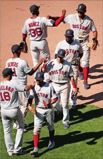  ?? CHARLIE RIEDEL/AP PHOTO ?? Red Sox players celebrate as they leave the field following a 7-4 win over the Royals on Sunday in Kansas City, completing a three-game weekend sweep to remain atop the American League East.