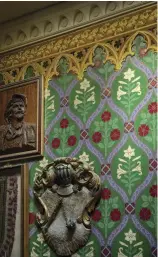  ??  ?? LEFT TO RIGHT A Gothic oak settee separates the great room from the entry hall; the low, carved and paneled ceiling creates richness and intimacy. • Joan of Arc stands guard above an oak cabinet. • Mixed patterns create a rich welcome; this is Zuber’s ‘Gothique’ border with ‘Gothic Lily’ from Cole & Son.