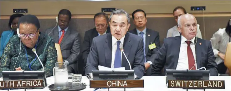  ??  ?? Chinese State Councilor and Foreign Minister Wang Yi (middle) addresses the commemorat­ion of the 70th anniversar­y of the signing of the Geneva Convention­s at the UN headquarte­rs in New York, September 23, 2019.