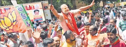  ?? ARIJIT SEN/HT PHOTO ?? BJP supporters celebrate outside the party office after Karnataka poll results on Tuesday. The BJP has once again underlined its growing dominance in India’s political landscape. Prime Minister Narendra Modi and party president Amit Shah are rightly...