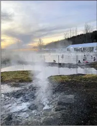  ?? (AP/Beth Harpaz) ?? Steam rises from hot springs that supply geothermal­ly heated water for the Secret Lagoon in the Hverahólmi geothermal area off Iceland’s Golden Circle route. The lagoon’s outdoor pool is open year-round with water heated to just over 100 F (38-40 C).