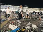  ?? Picture: AFP ?? PANIC AFTERMATH: Juventus supporters look for personal belongings after a stampede sparked by a bomb scare