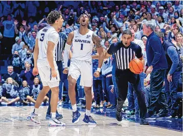  ?? AARON DOSTER/ASSOCIATED PRESS ?? Xavier’s Colby Jones, left, and Paul Scruggs celebrate after a play during their upset of No. 19 Ohio State on Thursday night in Cincinnati.