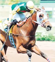  ??  ?? WISE JOHNNY (Hakeem Pottinger up) capturing the second race on Ash Wednesday at Caymanas Park.