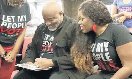  ?? JOHN RAOUX/ASSOCIATED PRESS ?? Former felon and president of the Florida Rights Restoratio­n Coalition Desmond Meade, left, fills out a voter registrati­on form as his wife Sheena looks on at the Supervisor of Elections office on Jan. 8, 2019, in Orlando.