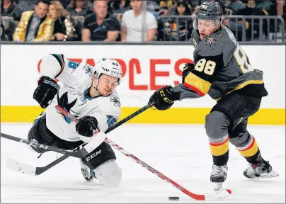  ?? AP PHOTO ?? San Jose Sharks’ Tomas Hertl battles for the puck with Vegas Golden Knights’ Nate Schmidt during an NHL game on March 8 in Las Vegas.