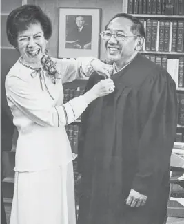  ?? THE REPUBLIC ?? Pearl Tang prepares her husband, attorney Thomas Tang, for swearing-in ceremonies of the 9th U.S. Circuit Court of Appeals in 1977.