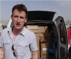  ??  ?? File photo released by the Kassig Family shows Peter Kassig with a truck, taken somewhere along the Syrian border between late 2012 and fall 2013. — AFP photo