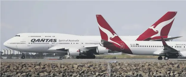  ??  ?? 0 Qantas pilots Captain Sean Golding, left, and first officer Jeremy Sutherland in the cockpit of the Boeing 787 Dreamliner plane that flew nonstop from New York to Sydney, far right, and Qantas boss Alan Joyce, right, and crew disembark at Sydney Internatio­nal Airport