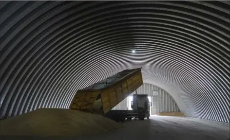  ?? EFREM LUKATSKY — THE ASSOCIATED PRESS ?? A dump track unloads grain in a granary in the village of Zghurivka, Ukraine on Tuesday. A ship approached Ukraine on Friday to pick up wheat for hungry people in Ethiopia, in the first food delivery to Africa under a U.n.-brokered plan to unblock grain trapped by Russia’s war and bring relief to some of the millions worldwide on the brink of starvation.