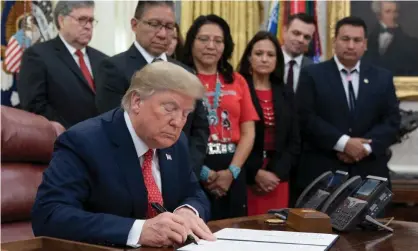  ?? Photograph: Chris Kleponis/POOL/EPA ?? Donald Trump signs an executive order Tuesday on establishi­ng the Task Force on Missing and Murdered American Indians and Alaska Natives.