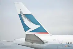  ??  ?? The Cathay Pacific logo is seen on the tail of a passenger plane as it prepares to take off from Hong Kong’s internatio­nal airport. — AFP photo