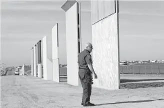  ?? K.C. Alfred / San Diego Union-Tribune / TNS ?? Border wall prototypes stand near San Ysidro, Calif., on the border with Mexico. The Trump administra­tion has softened its stance on having a physical wall along the entire border.