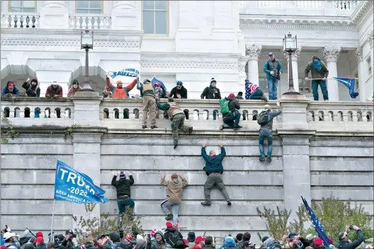  ??  ?? Supporters of President Donald Trump climb the west wall of the the U.S. Capitol on Wednesday in Washington. (AP Photo/Jose Luis Magana)