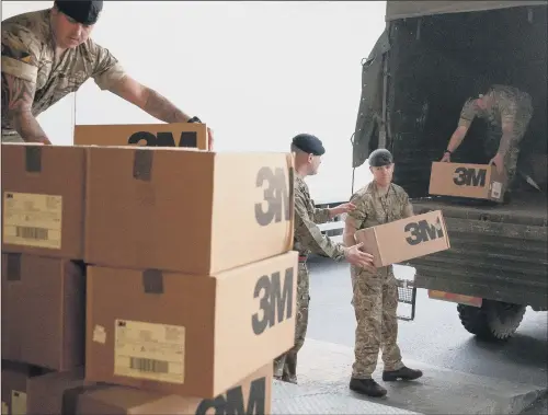  ?? PICTURE: LEON NEAL/GETTY IMAGES ?? ARMY SUPPORT: Soldiers delivering medical masks to St Thomas’ Hospital in central London yesterday. A temporary hospital is also to be set up in the capital.