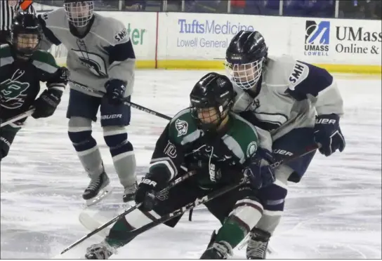  ?? JULIA MALAKIE — LOWELL SUN ?? Billerica/chelmsford’s Remoré Serra has the inside position on St. Mary’s Katy Sarazen during state tournament girls hockey action Sunday at the Tsongas Center. St. Mary’s was a 6-3winner.