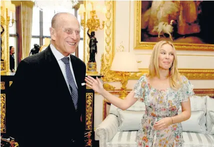  ?? WPA Pool ?? > Prince Philip presents Kylie Minogue with the Britain-Australia Society Award for 2016 during a private audience in the White Drawing Room at Windsor Castle