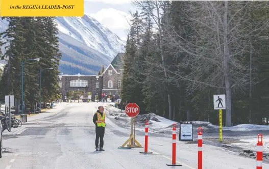  ?? MIKE DREW/POSTMEDIA NEWS ?? A staffer controls access to the Banff Springs Hotel in Banff, Alta., which is preparing to reopen for tourism — and possibly an influx of COVID-19 cases, some fear.