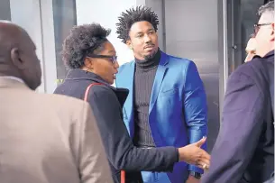  ?? SETH WENIG/ASSOCIATED PRESS ?? Cleveland Browns defensive end Myles Garrett, back, leaves an appeals hearing in New York Wednesday. Garrett’s indefinite suspension was upheld.