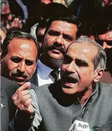  ?? Online ?? Federal Minister for Railway Khawaja Saad Rafique addresses journalist­s during their protest yesterday. Rafique said his colleague had taken a journalist’s phone since recording a video inside the Supreme Court is illegal.