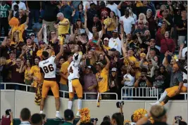  ?? ASSOCIATED PRESS ?? ARIZONA STATE players celebrate with fans following Saturday’s game against Michigan State in East Lansing, Mich.