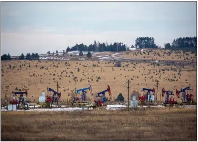  ?? (Bloomberg News/Andrey Rudakov) ?? Oil pump jacks operate last month in an oil field in Russia’s Udmurt Republic. The coronaviru­s pandemic is a key issue for oil ministers when they meet this week.