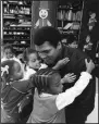  ?? (Courtesy of PBS) ?? Muhammad Ali is surrounded by young students during a visit to his old grammar school in Louisville, Ky, circa 1977.