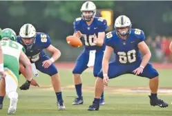  ?? STAFF PHOTO BY ROBIN RUDD ?? Walker County’s Ethan West (65) and Skyler Mullins (60) prepare to block for quarterbac­k Tucker Pope during the Mustangs’ Sept. 4 game at Rhea County.