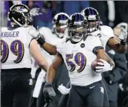  ?? JIM ROGASH/ GETTY IMAGES ?? Dannell Ellerbe celebrates with his Ravens teammates after intercepti­ng a Tom Brady pass on Sunday in Foxboro, Mass.