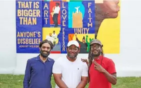  ?? Sean Eaton ?? Sohrab Mohebbi, left, James “Yaya” Hough and DS Kinsel at the unveiling July 30 of “A Gift to the Hill District,” a mural at 2318 Centre Ave. created for the Carnegie Internatio­nal.