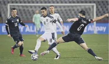  ??  ?? 0 Kieran Tierney battles for the ball with Serbia midfielder Dusan Tadic.