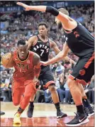  ?? Cole Burston /
The Canadian Press via AP ?? Atlanta’s Dennis Schroder (17) drives to the net during the first half against Toronto.