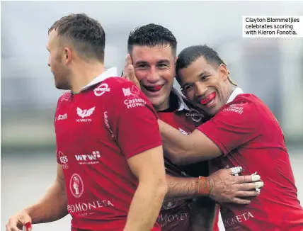  ??  ?? Clayton Blommetjie­s celebrates scoring with Kieron Fonotia.