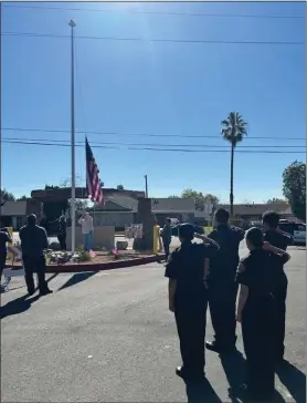  ?? COURTESY PHOTO ?? Paul and Emil Marzullo, brothers of the late Anthony “Tony” Marzullo, raise the flag for the first time on the flagpole at San Bernardino’s Wildwood Park, dedicated Jan. 28 in Marzullo’s memory. Members of the Public Safety Academy color guard salute as the flag is raised.