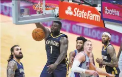  ?? Gerald Herbert / Associated Press ?? New Orleans forward Zion Williamson dunks during the second half of the Pelicans’ 128118 victory over the visiting Pistons.