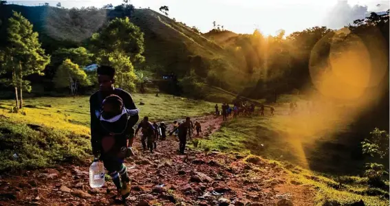  ?? Photograph­y by Marie D. De Jesús
STAFF PHOTOGRAPH­ER ?? About 90 migrants leave the Las Tecas camp in Acandí, Colombia, to enter the jungle of the Darién Gap, the only way to reach North America by land, on Nov. 6.