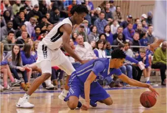  ?? STAFF PHOTO ?? McCallie’s Jr. Clay snags a loose ball ahead of Hamilton Heights’ Shai Gilgeous-Alexander during a Dr Pepper TEN Classic game in February 2017 at McCallie. The eighth edition of McCallie’s event, currently known as the Dr Pepper Classic, is Friday and Saturday.