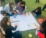  ??  ?? Artists join children in a live art painting session at Windsor Park in Dubai as part of the National Day celebratio­ns.